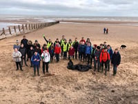Students get stuck in at beach clean