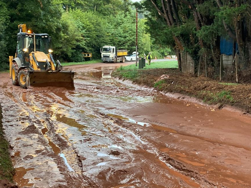 The flooded A358 near Combe Florey, Somerset - caused by a potato field mudslide. See SWNS story SWMRmud. Highway workers are seen in a clear-up operation after flash floods cause a potato field to collapse and swamp a road.The A358 near Combe Florey, Somerset, just outside Bishops Lydeard and near Taunton, has been shut with a diversion route in place.  Somerset County Council has a highways team at the scene, who are using diggers in an attempt to clear the extensive sludge covering the roads.Somerset County Council - @TravelSomerset - posted the images at 7:12am this morning (6 September), writing: "Here's the scene on the A358 at Combe Florey this morning after last night's mudslide. 