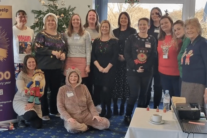 Pictured: The Reminiscence Learning 20th anniversary year appeal being launched at the Taunton and Pickeridge Golf Club with the charity chief executive Fiona Mahoney in the reindeer outfit sat on the floor.