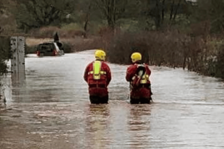 Firefighters rescue a stranded motorists near Wellington