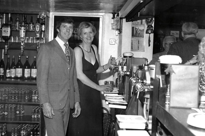 Merv and Heather Procter behind the bar at the Merry Harriers
