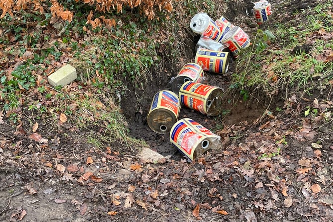 Cans dumped at the side of the road
