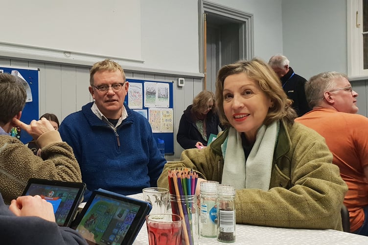 Wellington MP Rebecca Pow with Baptist minister the Rev Sam Griffiths talking with people using the warm refuge