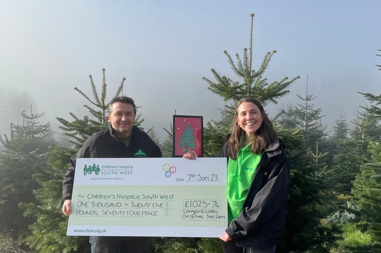 Nick Hendy from Langford Lakes Christmas Tree Farm donates a cheque for the money raised to Mary Gray, Area Fundraiser at Children’s Hospice South West