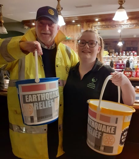 Rotarian Miles Halliwell collecting in The Green Dragon with staff member Molly Menear.