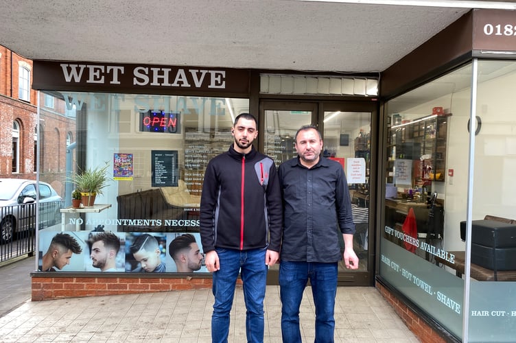 Kozad Hamasalih and Yasar Eren in front of of Taji Turkish Barbershop on the High Street
