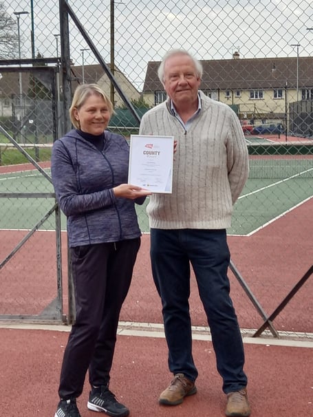 Chairman of Wellington Tennis Club Sue Rackley pictured receiving the 2021 Volunteer of the Year award from Somerset LTA Chairman Andy Fay