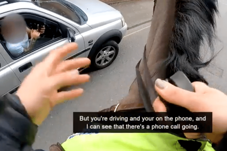 Body cam footage shows the moment mounted police caught up with and stopped a driver for using his mobile phone