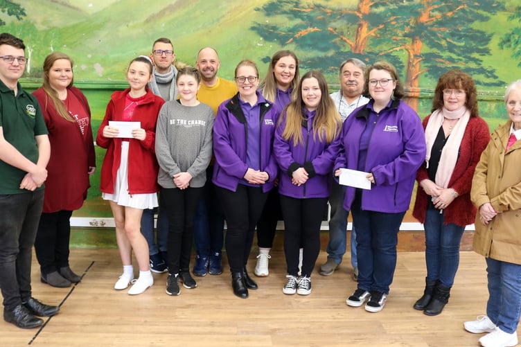 Charity fundraisers accept their cheque from the Wellington Carnival after collecting at the event last September