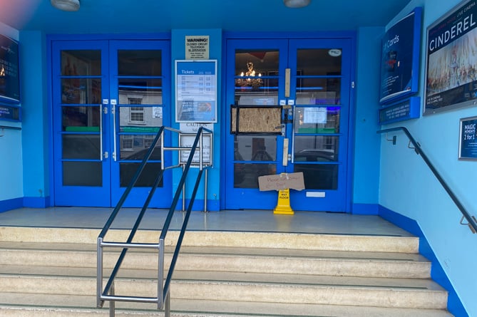 The front door of the cinema was boarded up on Tuesday after it was smashed in with a rock