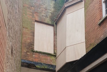 The hazardous bay window appears to have been clad in hoarding to prevent further rubble falling