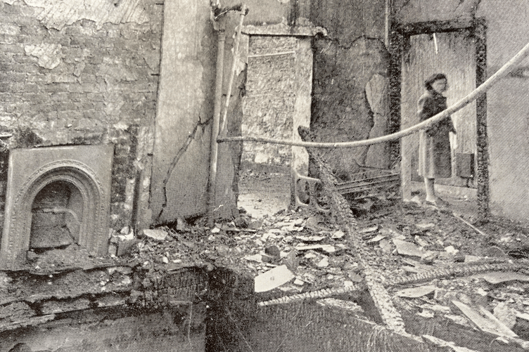 An image from the fire aftermath, showing a collapsed ceiling between the tailoring room and the matron's dress making department