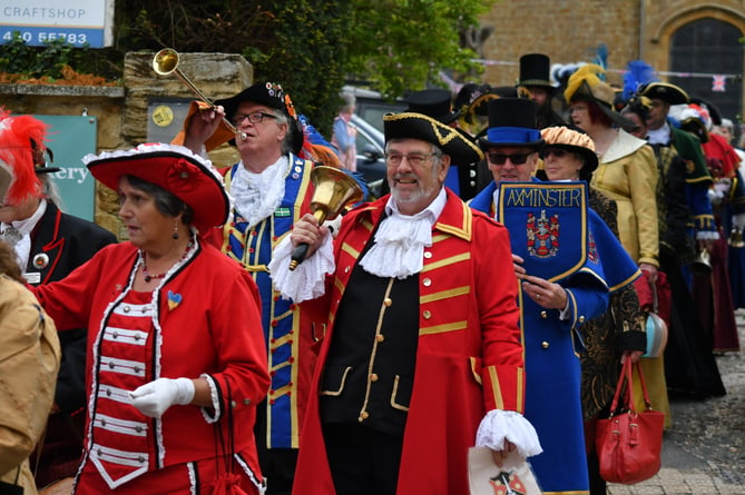 Wellington town crier Andrew Norris (centre, red tunic) during a parade of town criers ahead of a competition in Ilminster.