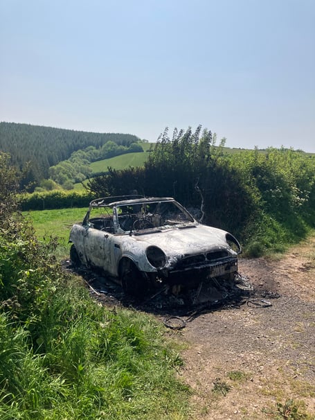 The remains of a torched car were discovered near the Church of St Michael on Monday morning