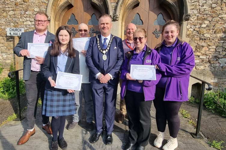 Mayor of Wellington, Cllr Marcus Barr (centre), and clerk to Wellington Town Council, Dave Farrow (third from right), are pictured with community award recipients.