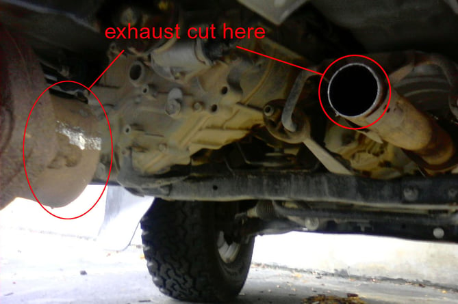 An image of a car after having its catalytic converter cut away and stolen