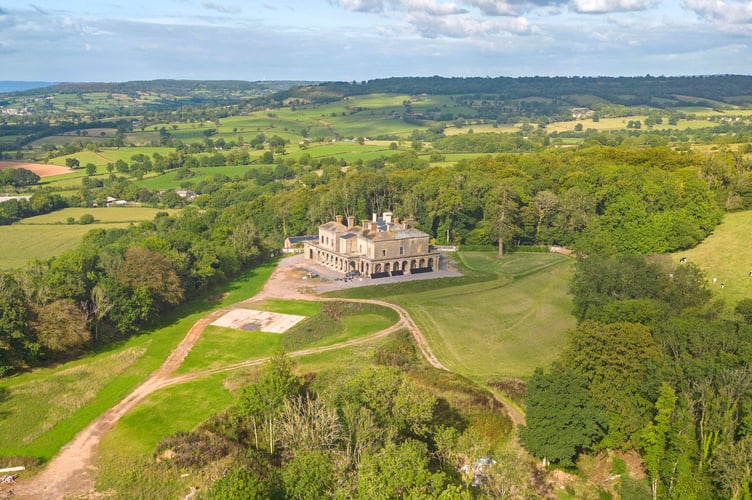 Blackborough House in the Blackdown Hills, on the Somerset-Devon border. See SWNS story SWLNderelict. The opportunity to restore a crumbling architectural gem in Devon is up for grabs for just under £1.5 million.Despite its grand façade, the Grade II Listed country mansion was never completed and is currently derelict and in need of a complete renovation.Blackborough House has 14-bedrooms, 15 bathrooms and nine reception rooms, and was designed to be an Italianate palace.It is nestled in Blackdown Hills, which spreads along the border between Somerset and Devon and has been named an Area of Outstanding Natural Beauty.