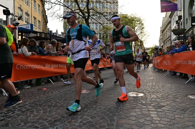 Matt (right) pictured running the Night Marathon in Luxembourg
