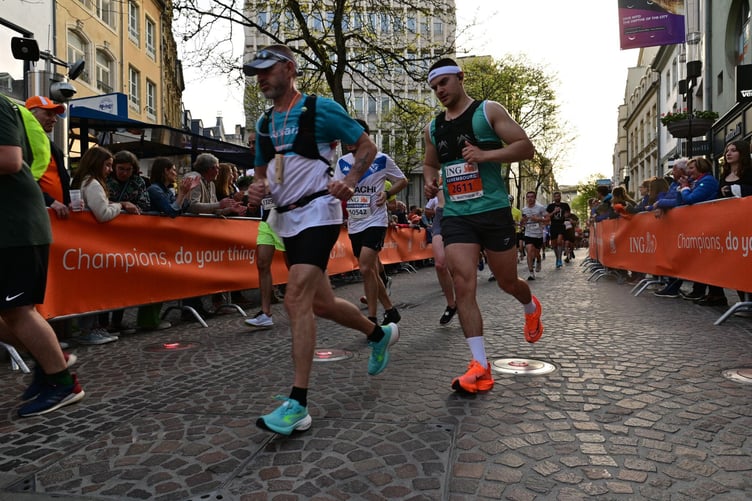 Matt (right) pictured running the Night Marathon in Luxembourg