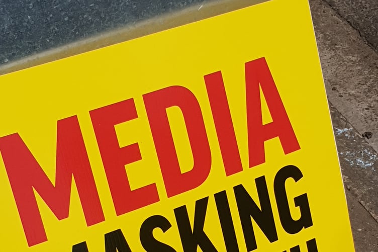 One of the placards being displayed by conspiracy theorists at Wellington Street Fair.