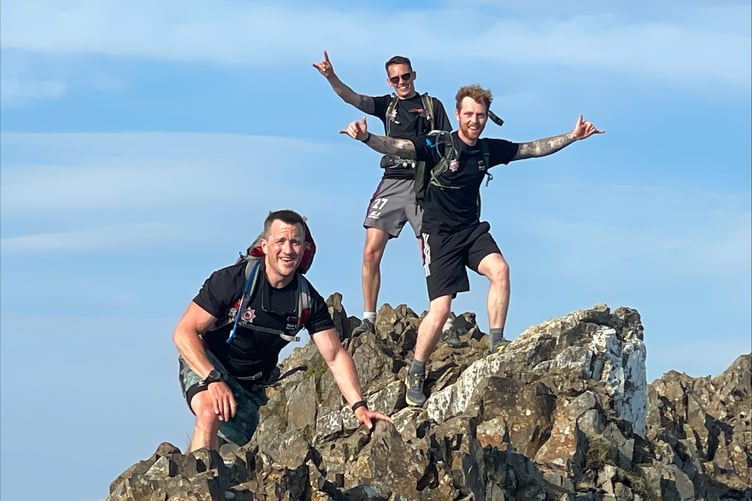 A team of fire fighters have scaled 14 peaks in aid of raising money for charity