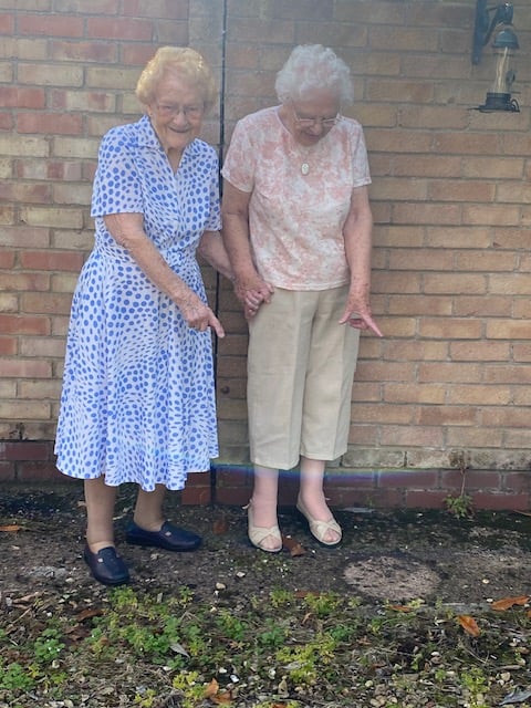 Members of the gardening club point to the site of their missing pots