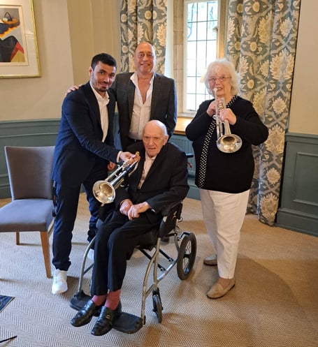 Retired jazz singer Geoff Brown (seated) with (left to right) jazz trumpeter Luis Martelo, son Peter, and wife Rita.
