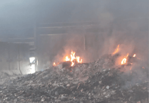 Damage to recycling centre seen in new photographs as fire still burning four days on