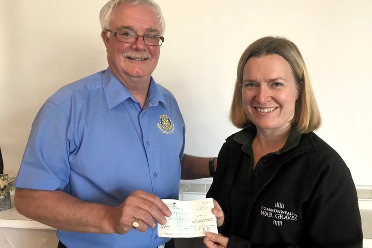 Rotary past President Mike Webb presents a cheque for £100 to Rebecca Smith, of the Commonwealth War Graves Commission.