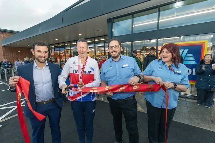ParalympicsGB athlete Hannah Taunton cuts a ribbon to open Aldi's newest store.