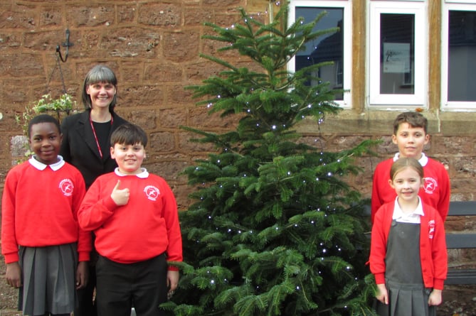Senior teacher Heather Davidson with some of the Langford Budville School pupils who helped collect their Christmas tree.