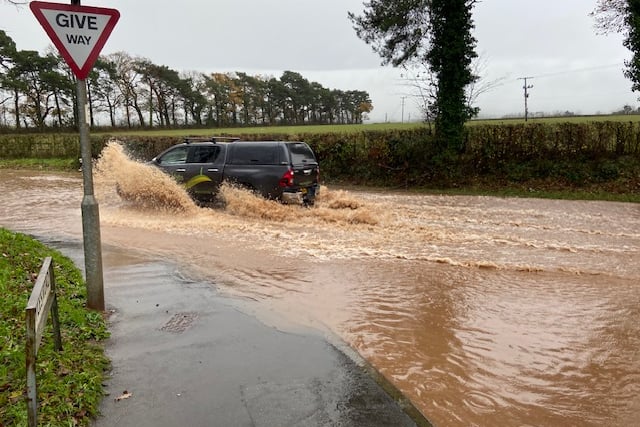 A van ploughs its way through floods on Wellington Relief Road.