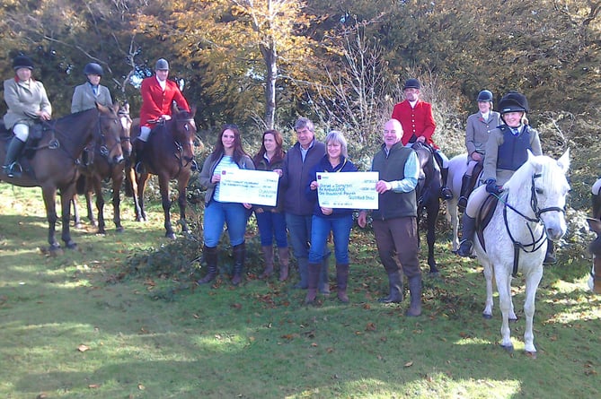 Dorset and Somerset Air Ambulance was presented with two cheques from the Quantock Staghounds.