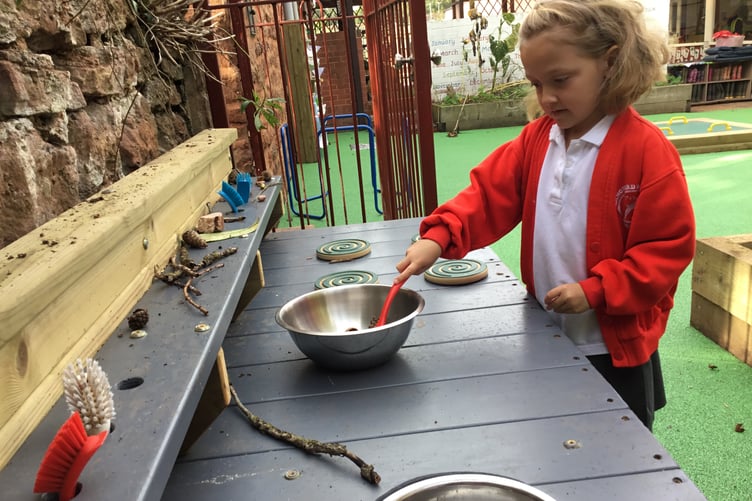 Using a 'mud kitchen' in Langford Budville School's new early years outdoor area.
