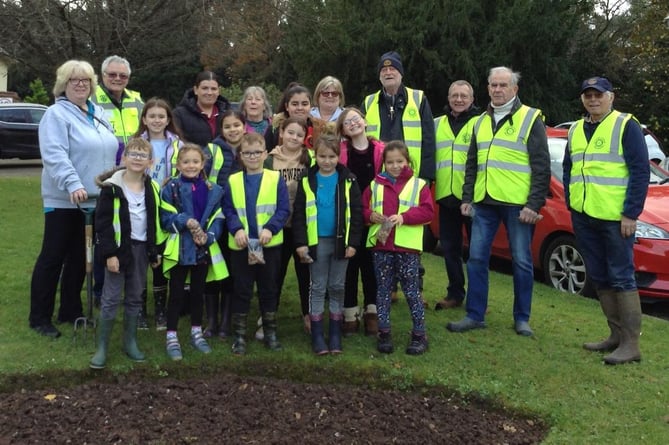 Rotary members and and Wellesley Park School pupils planted purple crocus bulbs in the grounds of the school and also Oaktree Court care home.