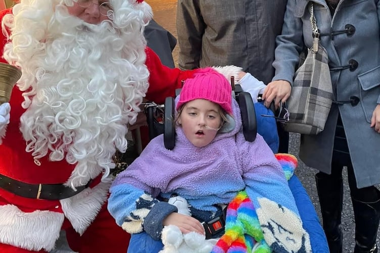 Ten-year-old Harper Pumfrey meets Santa in Taunton.