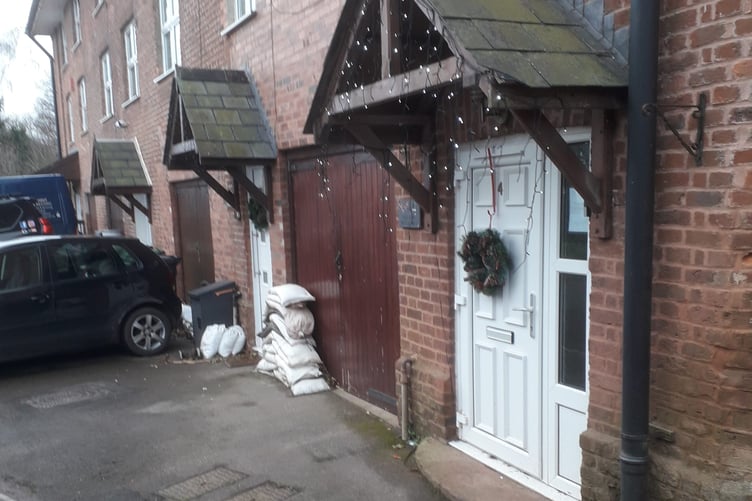 Sandbags can be seen stacked and ready for use in a future flooding event in Westford, Rockwell Green.