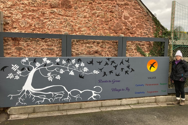 Artist Christine Sowden with a mural she has given to Langford Budville Primary School.