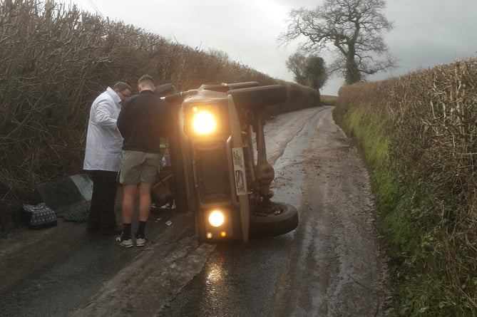 Marcus Fudge, of Tim Potter's butchers (in white coat), and a passing jogger attempt to break the crashed Land Rover's windscreen.