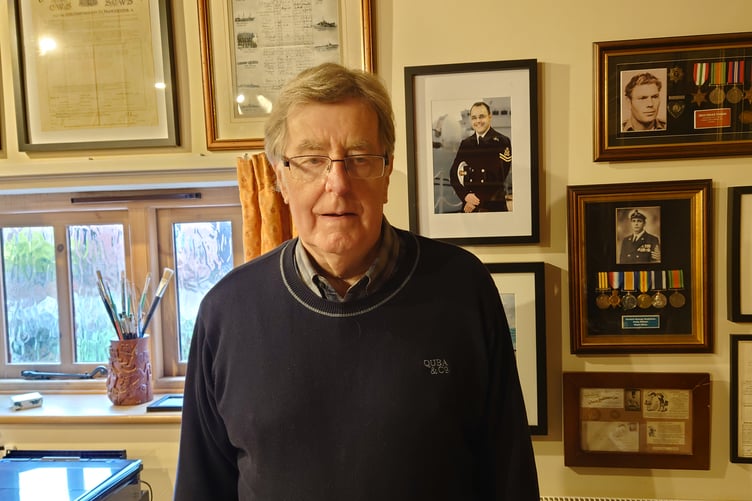 Alan Tromas, pictured in front of his grandfather's war medals and service records