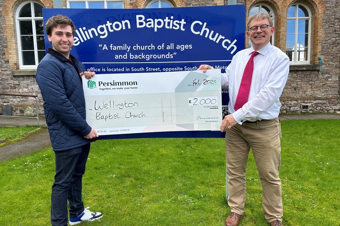 Wellington Baptist Minister the Rev Sam Griffiths (right) receives a cheque for the church's Warm Place from Persimmon Homes South West.