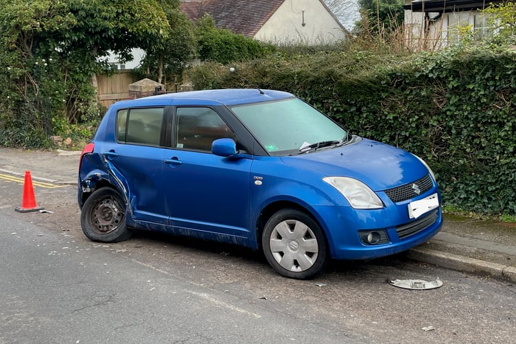 This Suzuki car was left with a wheel hanging off after it was hit by a vehicle and shunted into three other cars in Wellesley Park, Wellington.