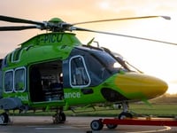 Air ambulance now taking off in green helicopter