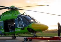 Air ambulance now taking off in green helicopter