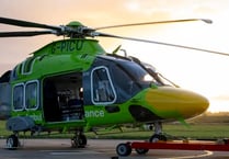 Air ambulance now taking off in green helicopter