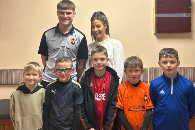 Wellington Reserves man-of-the-match Charlie Hawkings, pictured with Lauren Currie of award sponsors My Dentist and players from the U9s.