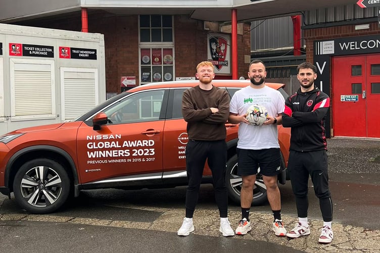 Jack Scadden (centre) in front of the Nissan X Trail.