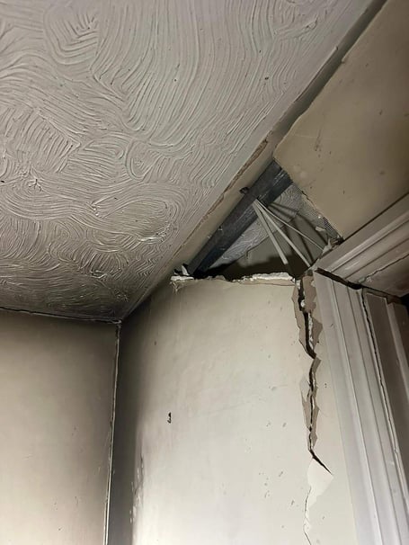 A hole in a wall of the property reportedly caused by an exploding aerosol can 