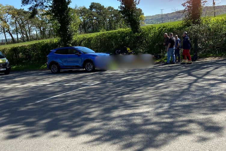A motorcyclist escaped serious injury after colliding with a car