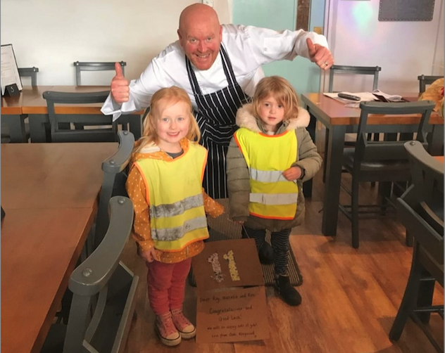 Roy Keeling in Uffculme's Café No 11 with some of the Kingwood Children who presented a welcome card.